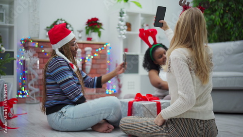 Girls take a selfie during Christmas. Fellow African and European girls.