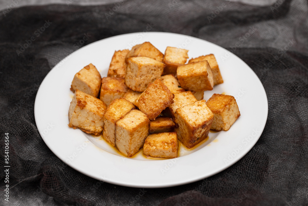crispy deep stir fried tofu cubes on small dish crispy deep stir fried tofu cubes on small dish