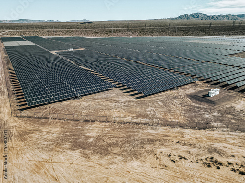 Renewable solar energy solar farm in the desert of southern Nevada on a dry lake bed gathering sun rays and photovoltaic energy to provide sustainable electricity to nearby Las Vegas and other areas photo