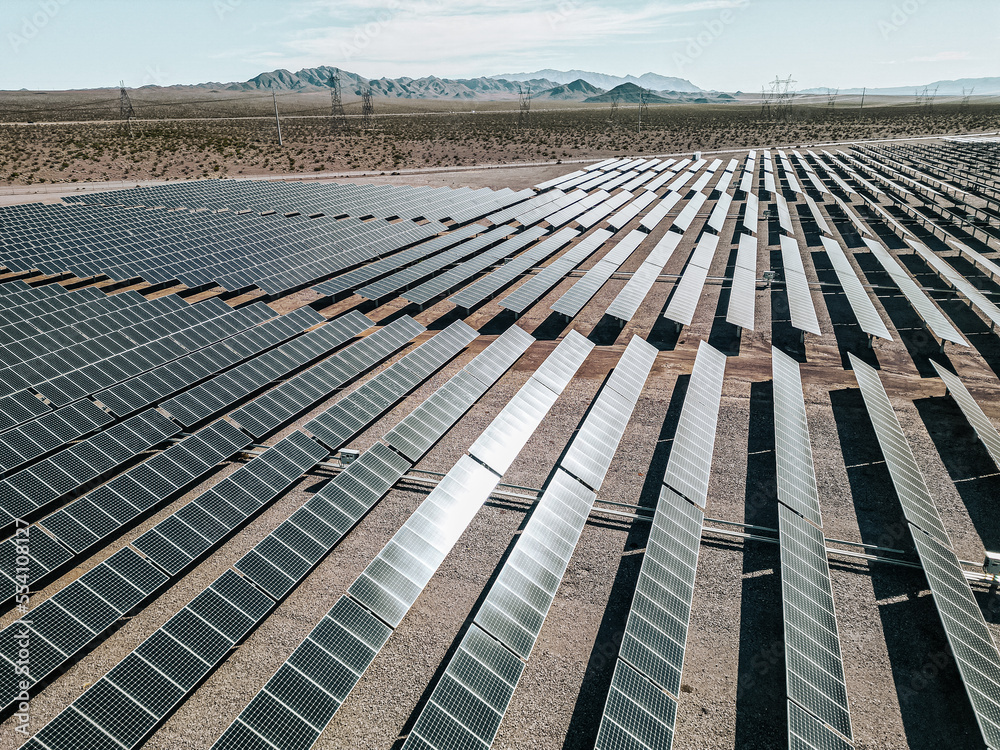 Renewable solar energy solar farm in the desert of southern Nevada on a dry lake bed gathering sun rays and photovoltaic energy to provide sustainable electricity to nearby Las Vegas and other areas Renewable solar energy solar farm in the desert of southern Nevada on a dry lake bed gathering sun rays and photovoltaic energy to provide sustainable electricity to nearby Las Vegas and other areas