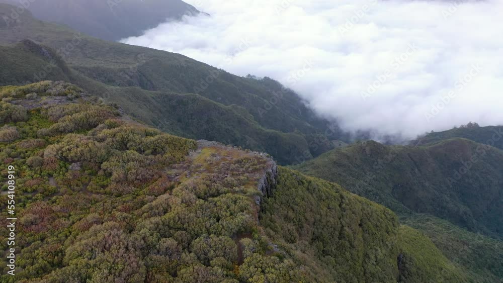 Awesome drone flight around a mountain in Madeira, Portugal. A great sunset with some wind mills in the background. Awesome drone flight around a mountain in Madeira, Portugal. A great sunset with some wind mills in the background.