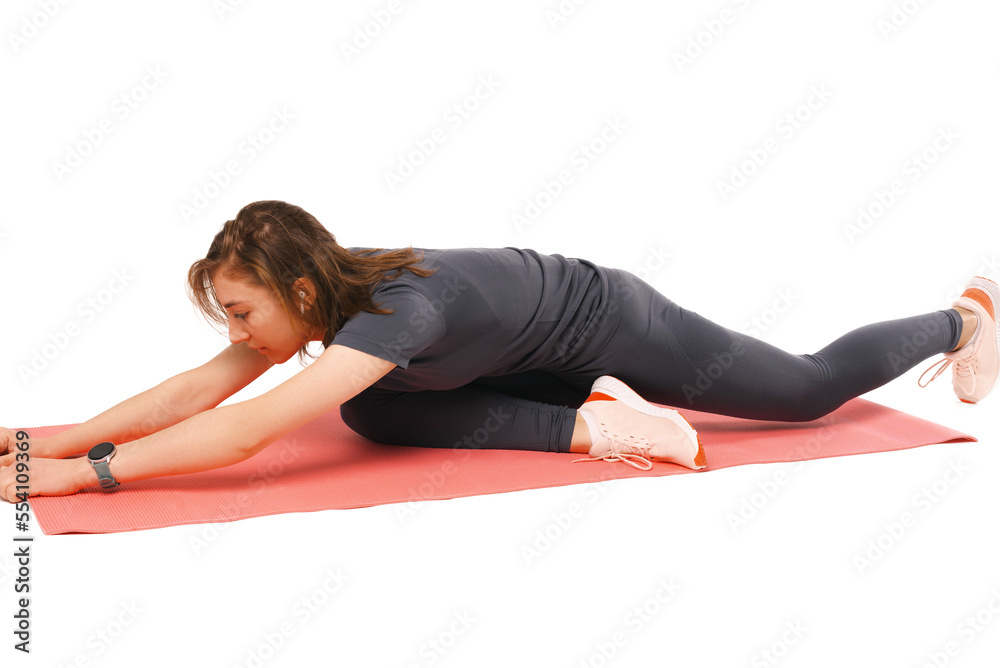 Young woman is making some stretching exercises on red mat in a white studio. Young woman is making some stretching exercises on red mat in a white studio.