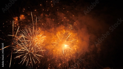 4k. Bright New Year's fireworks 2023. beautiful new year's eve. glowing loop christmas bokeh. holiday day christmas. beautiful bright color spot show. eve New Year's holiday. national festival sky.