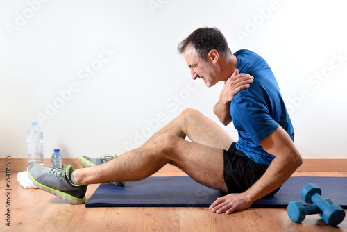 Man doing sport indoors complaining with clavicle pain photo