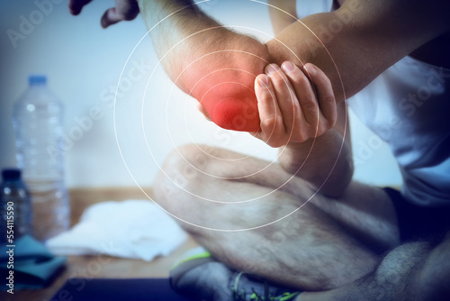 Representation of pain in the elbow in red on blue photo