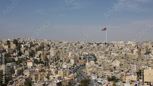 Huge Jordan flag in midtown Amman, landscape view of clear sky background