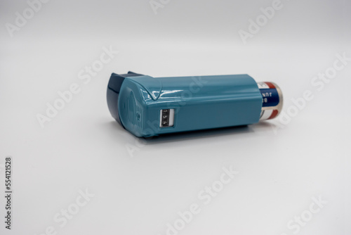 Selective focus on a blue inhaler on a white background photo