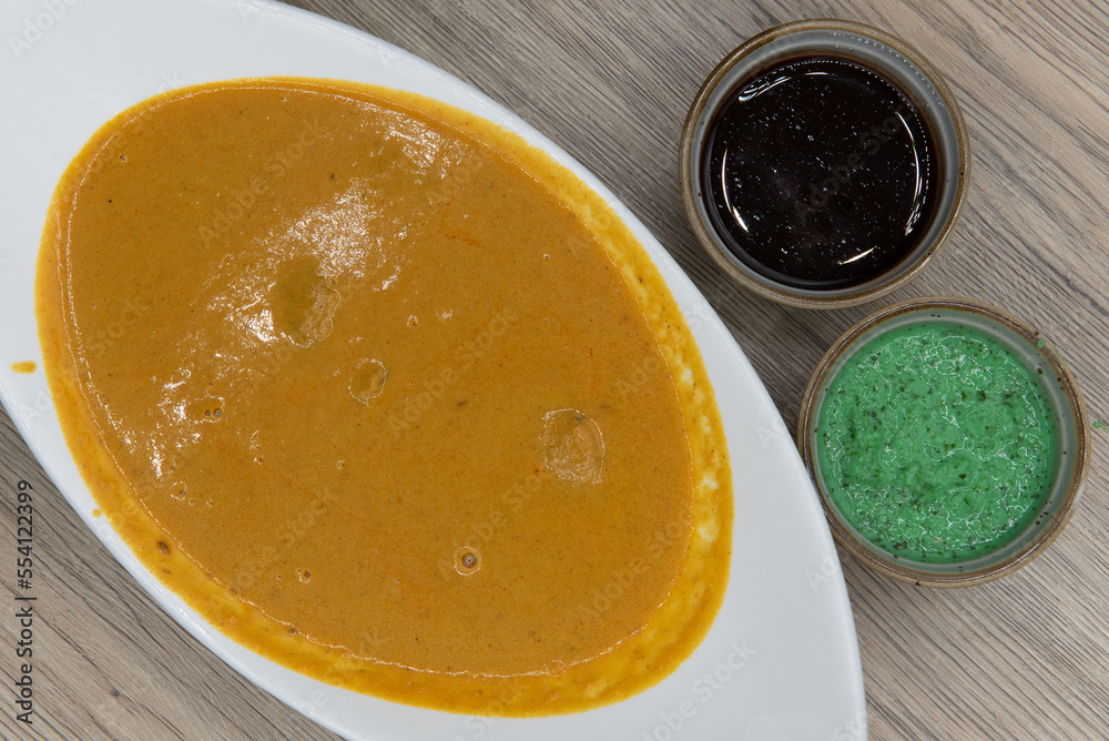 Overhead view of traditional Indian meal consisting of a bowl of shrimp korma and humus dipping sauce for extra flavor Overhead view of traditional Indian meal consisting of a bowl of shrimp korma and humus dipping sauce for extra flavor