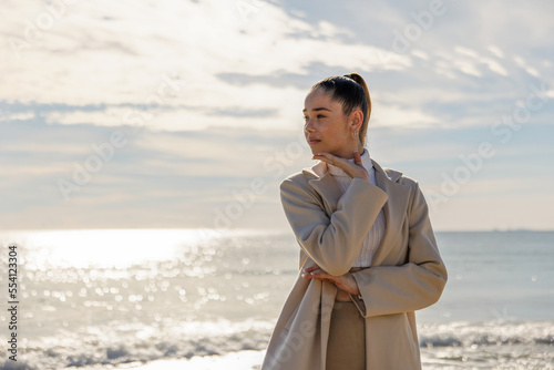 Portrait of a young pretty girl on the background of the sea