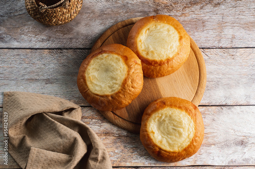 homemade buns with cottage cheese on a wooden board