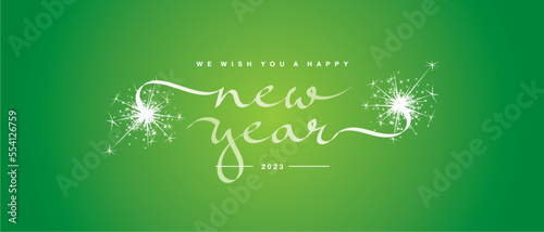 We wish you a Happy New Year 2023 unique modern ribbon calligraphic text with sparkler firework lucky green color background