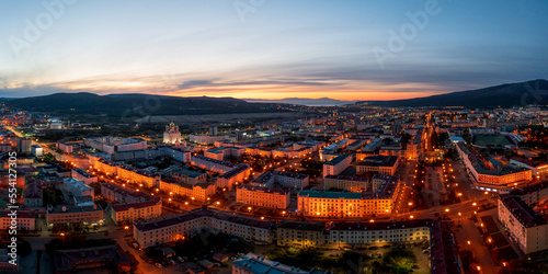 Night panoramic aerial photograph of the city of Magadan. Top view of the streets and buildings. Early morning, dawn. Magadan, Magadan region, Russian Far East. © Andrei Stepanov