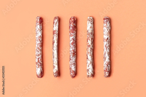 Flat lay of mini fuet snack sticks on the beige background