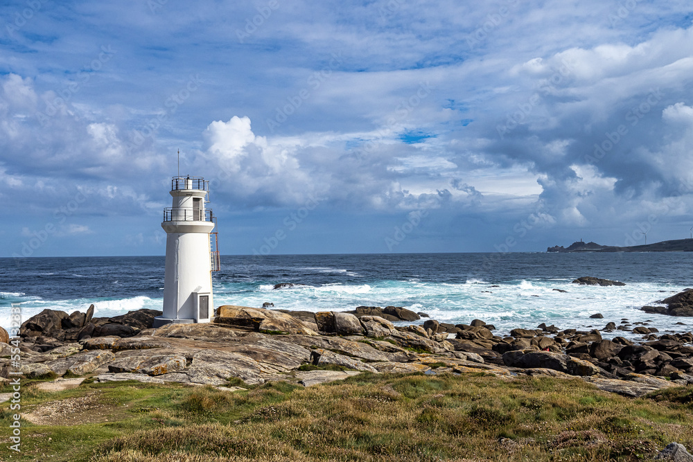 Lighthouse in Muxia on the Costa da Morte in Galicia, Spain. Cape Vilan in the background