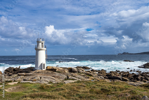 Lighthouse in Muxia on the Costa da Morte in Galicia, Spain. Cape Vilan in the background