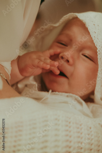 Billede på lærred portrait of a close-up baby in baptismal clothes in a Christian church during ba