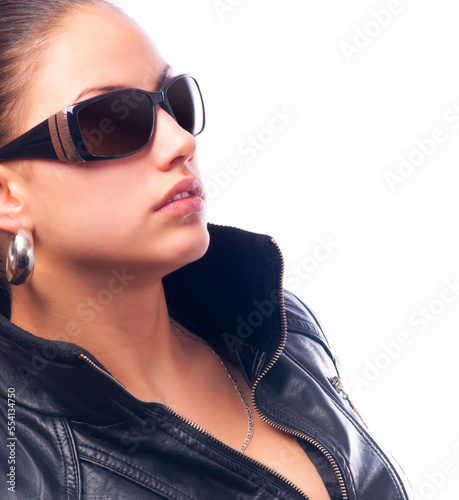 Beautiful young woman in leather jacket and sunglasses isolated on white background photo