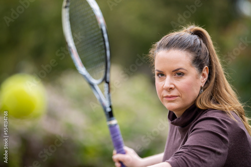 female tennis hitting tennis balls in summer