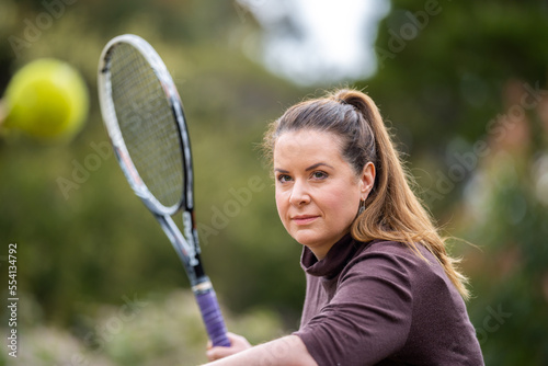 female athlete hitting tennis balls. woman playing social tennis