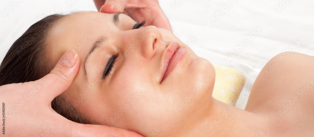 Young women getting a face massage in massage salon