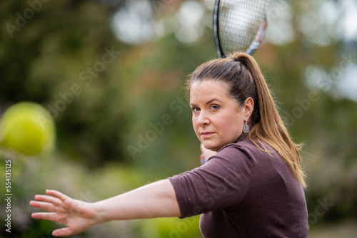 female tennis hitting tennis balls in summer