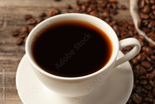 Cup of aromatic coffee on wooden table, closeup © New Africa