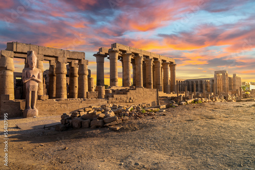 The ancient Karnak Temple along the River Nile under colorful evening skies in the city of Luxor Egypt.