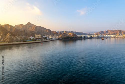 Early morning view from the sea of the old city  Mutrah Fort and Mutrah Corniche waterfront at the Port Sultan Qaboos of Muscat Oman along the Gulf of Oman in the Arabian Sea  