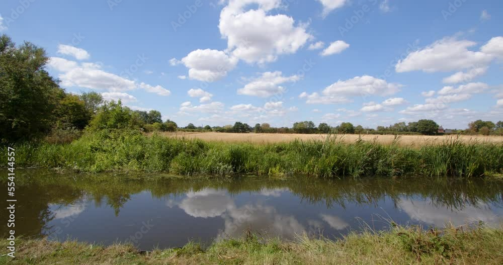 Straight on wide shot of British countryside with Trent and Mersey Canal on a sunny day Straight on wide shot of British countryside with Trent and Mersey Canal on a sunny day