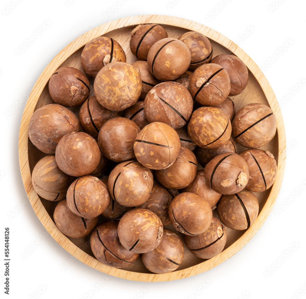 Roasted Macadamia nut in wooden plate on wooden background, Macadamia nuts on wooden background. Roasted Macadamia nut in wooden plate on wooden background, Macadamia nuts on wooden background.