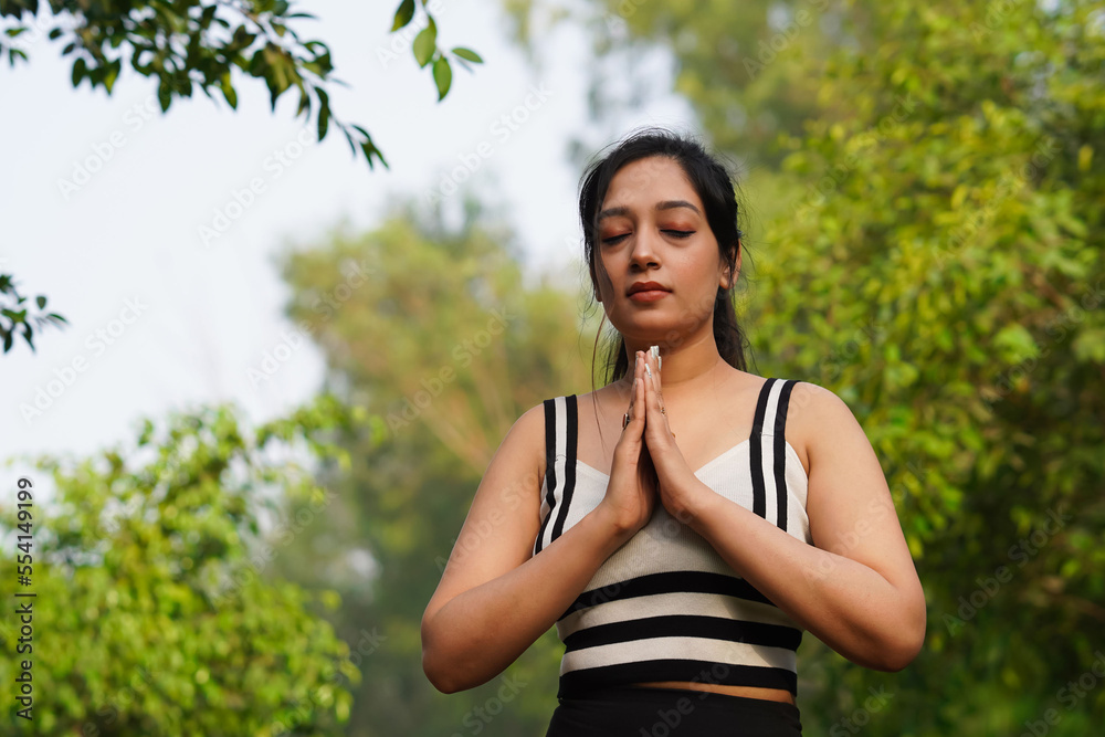 Beautiful young Indian woman doing Surya Namaskar Beautiful young Indian woman doing Surya Namaskar