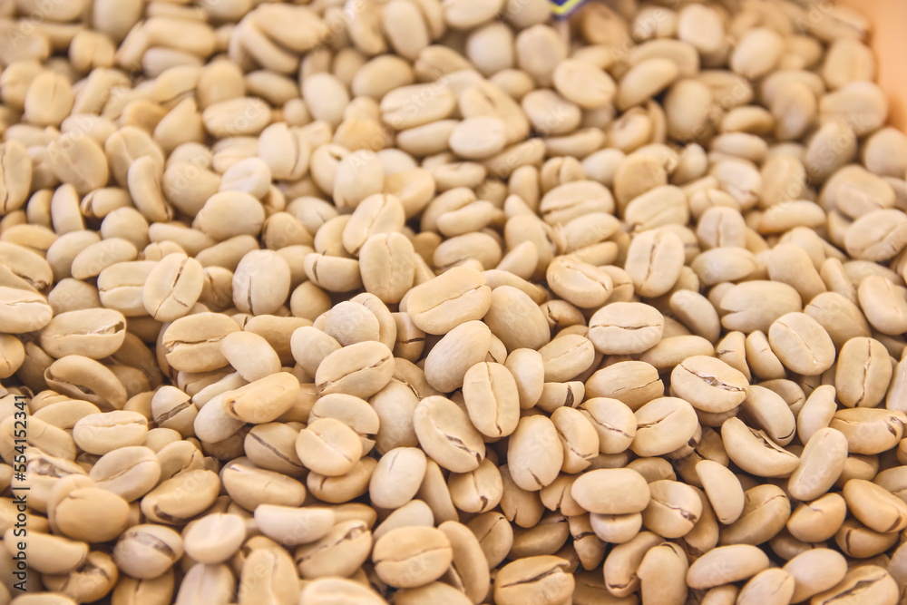 Close up raw coffee beans pile background Close up raw coffee beans pile background