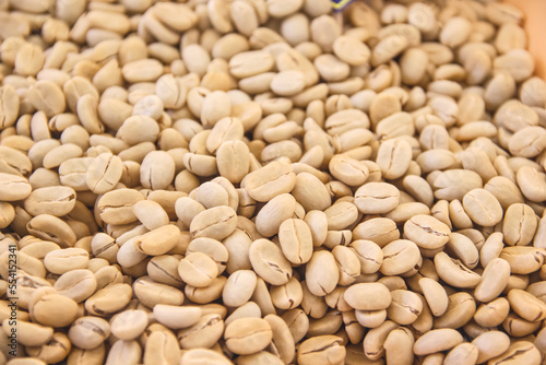 Close up raw coffee beans pile  background