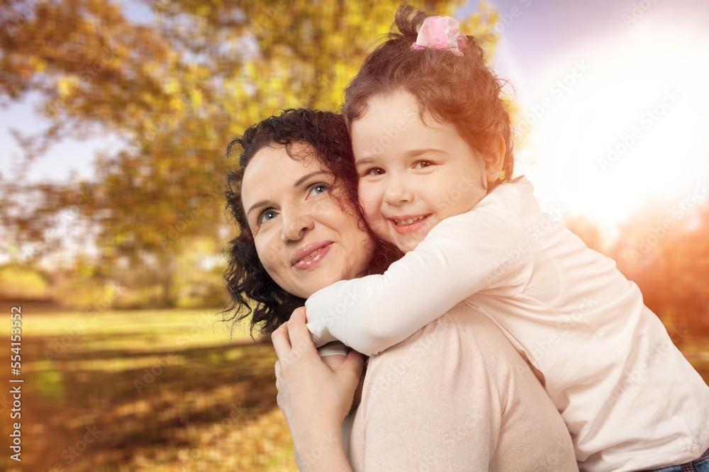 Happy young mother play with cute child in park Happy young mother play with cute child in park
