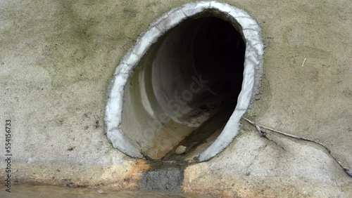 Drainage sewage tube flow polluted contaminated water into canal on an industrial zone