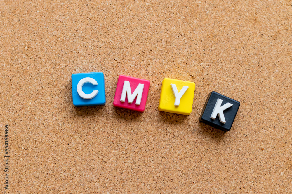 CMYK letter cubes with copy space on brown background. CMYK concept. CMYK letter cubes with copy space on brown background. CMYK concept.