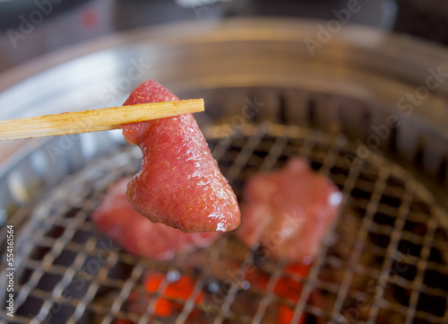 Grilled sliced beef tongue on fire charcoal