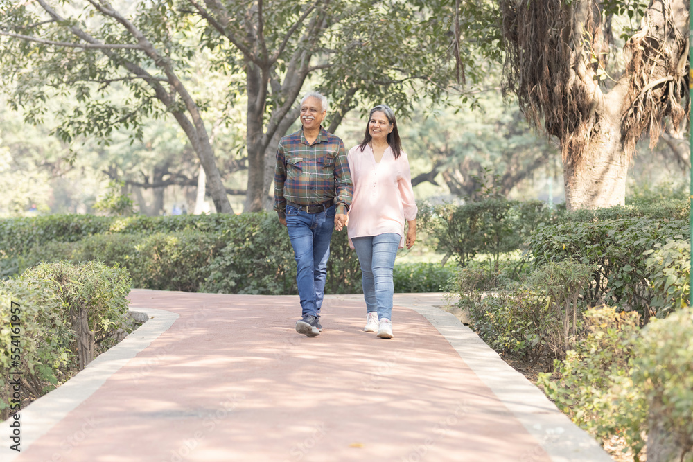 Happy senior couple spending leisure time in park during weekend Happy senior couple spending leisure time in park during weekend