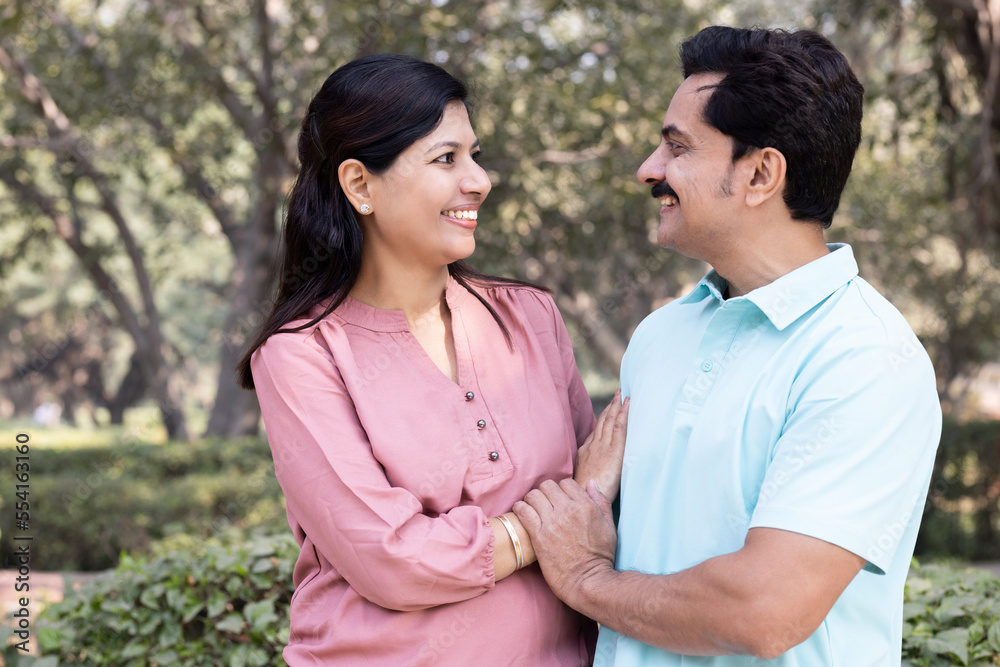 Couple having fun while admiring view at park Couple having fun while admiring view at park