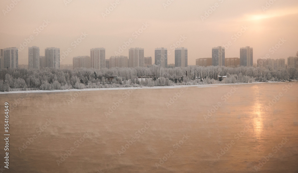 Winter sunset panoramic view of the Yenisei River and the city of Krasnoyarsk.