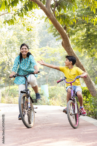 Family on a bike ride together outdoors on a sunny day.