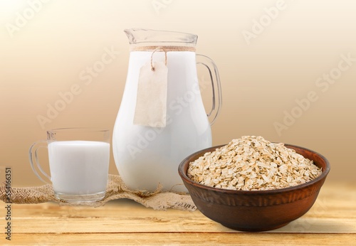 Fresh tasty oat milk dairy products on desk