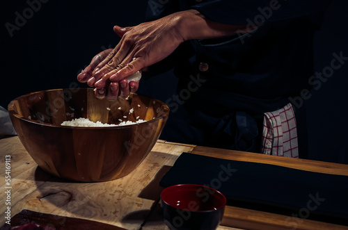 Japanese chef making rice nigiri sushi with tuna  salmon  shrimp traditional Japanese food  Dark Tone