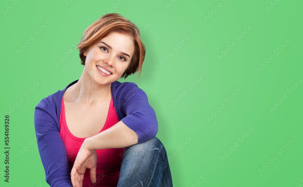 Happy beautiful young woman posing on the background Happy beautiful young woman posing on the background