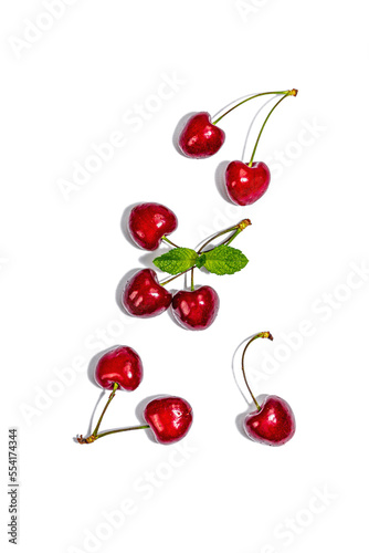 Ripe sweet cherries with fresh mint leaves isolated on white background. Traditional summer fruits