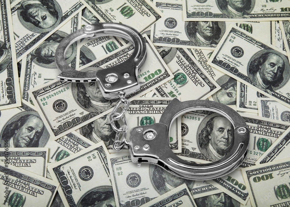 Corruption concept, money and steel handcuffs Corruption concept, money and steel handcuffs