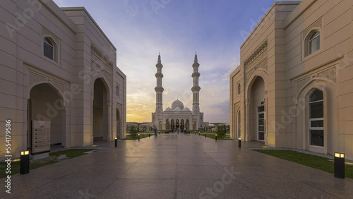 Beautiful sunset time lapse view of motion blur busy public entrance of a mosque in Negeri Sembilan, Malaysia. Zoom in motion timelapse. Prores 4KUHD photo