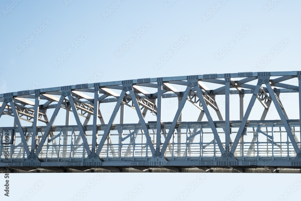 Iron frame bridge on clear sky background.