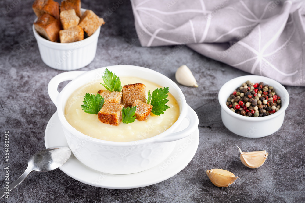Cauliflower potato soup puree on stone background, Creamy cauliflower soup with toasted bread croutons Cauliflower potato soup puree on stone background, Creamy cauliflower soup with toasted bread croutons