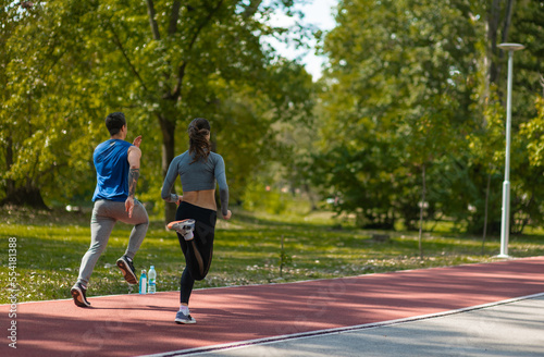Sporty friends doing short sprints in the park © qunica.com